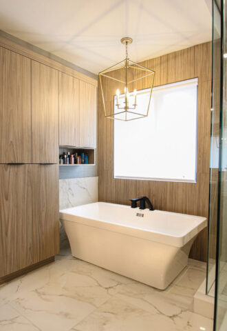 A spa-inspired bathroom combining soft textures and natural tones, creating a serene retreat with a freestanding soaking tub and refined finishes.